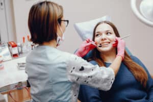 Patient receiving dental treatment at the dentist office with a smiling dentist Best Dentist in Laguna Hills